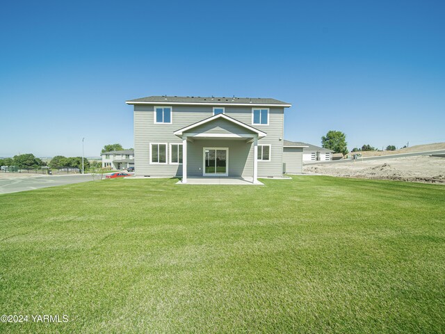 rear view of property with a patio area and a lawn