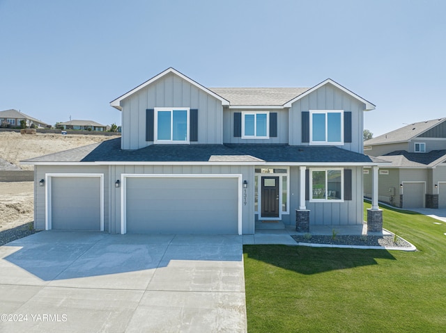 view of front of house with driveway, roof with shingles, an attached garage, board and batten siding, and a front yard