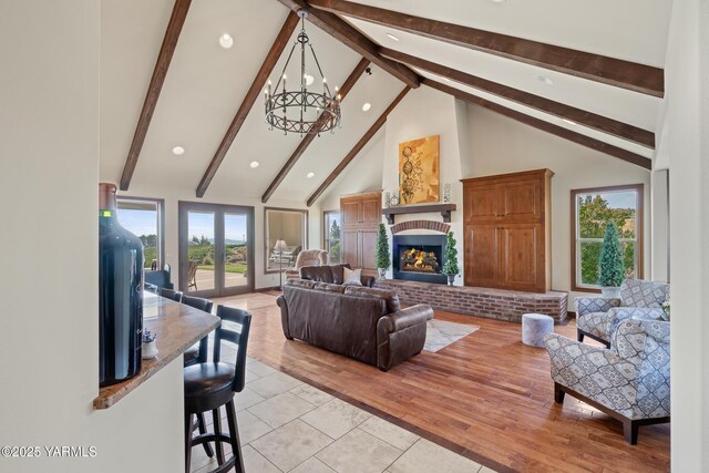 1893 Young Grade Rd, Yakima, WA 98908 - living room featuring a chandelier, beam ceiling, high vaulted ceiling, a brick fireplace, and light tile patterned floors