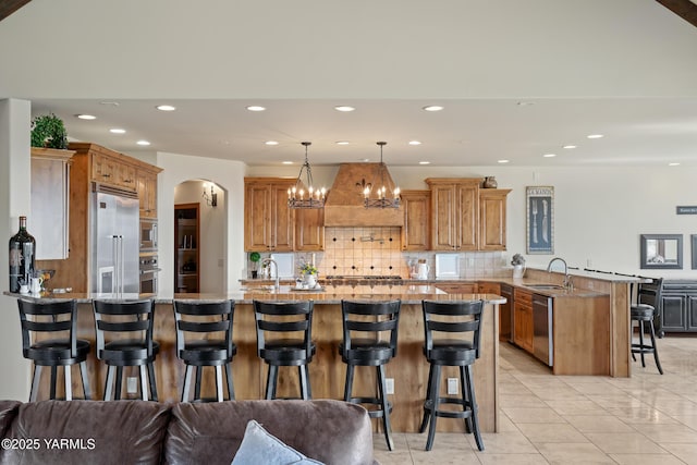 1893 Young Grade Rd, Yakima, WA 98908 - kitchen with built in appliances, a peninsula, a kitchen breakfast bar, recessed lighting, and light stone countertops