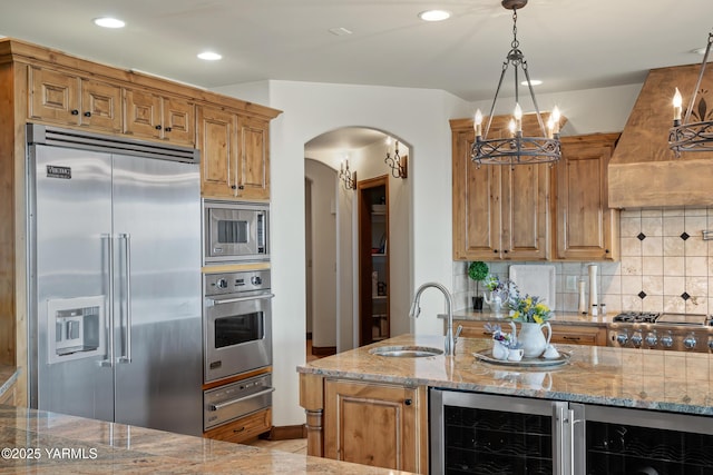 1893 Young Grade Rd, Yakima, WA 98908 - kitchen featuring built in appliances, a sink, beverage cooler, a warming drawer, and arched walkways