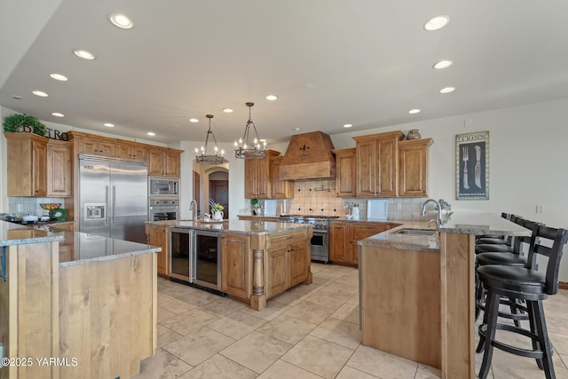 1893 Young Grade Rd, Yakima, WA 98908 - kitchen with built in appliances, custom range hood, a peninsula, recessed lighting, and a sink