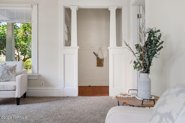 interior space featuring carpet floors and ornate columns