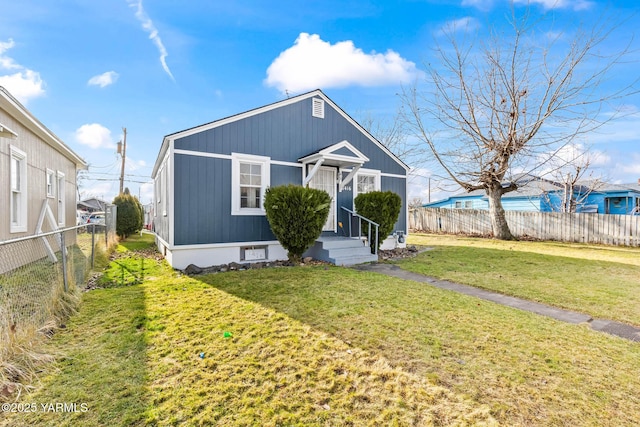 bungalow-style house featuring fence private yard and a front lawn