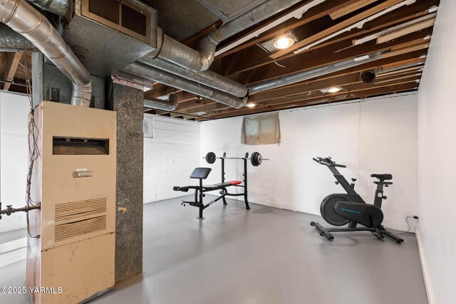 workout area featuring heating unit and visible vents