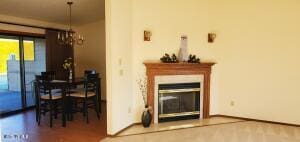 living room with wood finished floors and a glass covered fireplace