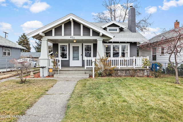 bungalow-style home with a front lawn and a porch