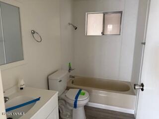 8108 Poplar View Way, Yakima, WA 98908 - bathroom featuring toilet, vanity, wood finished floors, and washtub / shower combination