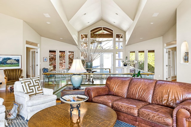 living room with high vaulted ceiling and wood finished floors