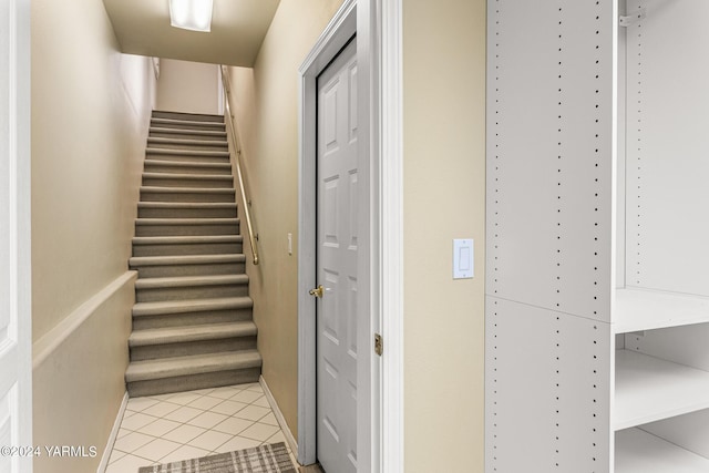 staircase featuring tile patterned flooring