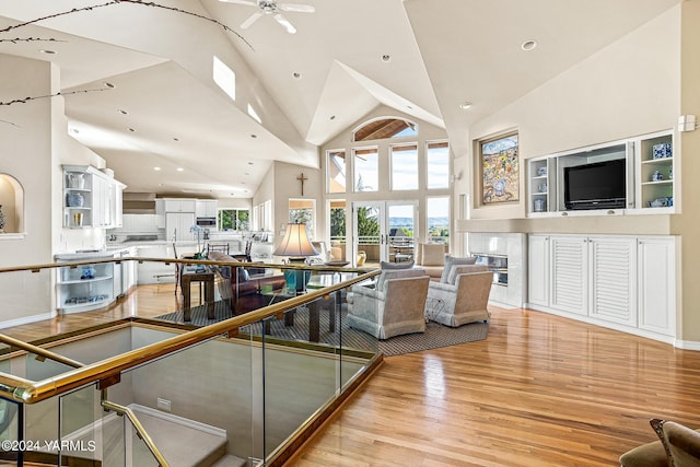 living area featuring high vaulted ceiling, recessed lighting, ceiling fan, and light wood finished floors