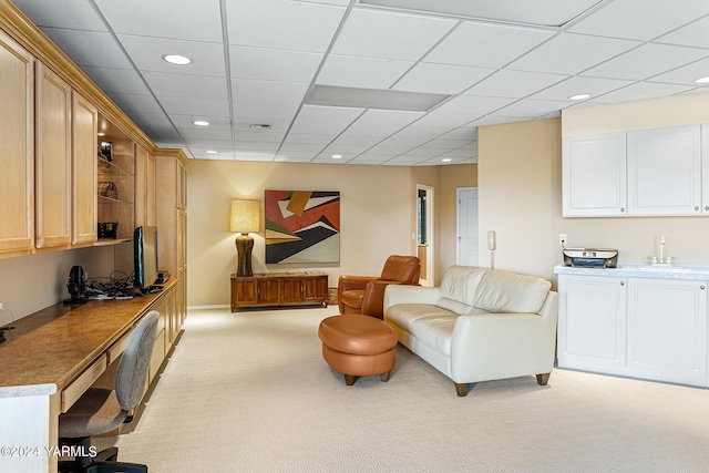 living area featuring recessed lighting, light carpet, and a paneled ceiling