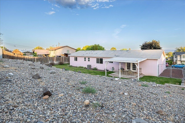 308 Merrick Ave, Sunnyside, WA 98944 - rear view of house featuring a patio, a fenced backyard, and central air condition unit
