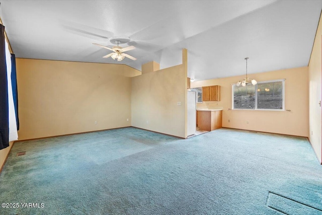 308 Merrick Ave, Sunnyside, WA 98944 - unfurnished living room featuring a ceiling fan, carpet, a chandelier, baseboards, and lofted ceiling