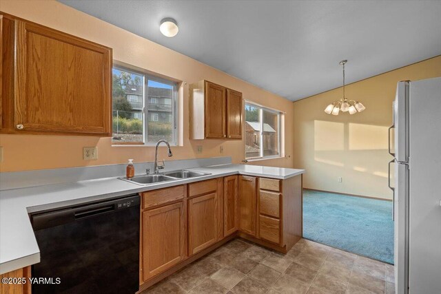 308 Merrick Ave, Sunnyside, WA 98944 - kitchen with freestanding refrigerator, black dishwasher, a sink, vaulted ceiling, and a peninsula