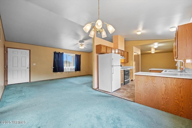 308 Merrick Ave, Sunnyside, WA 98944 - kitchen with freestanding refrigerator, a sink, light colored carpet, range with electric stovetop, and brown cabinetry