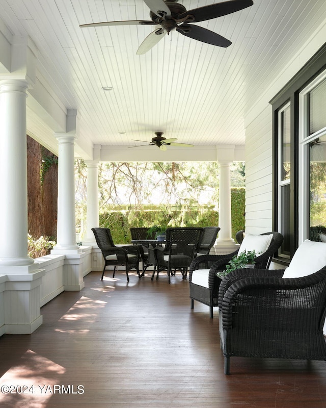 sunroom / solarium featuring a ceiling fan, a wealth of natural light, and ornate columns