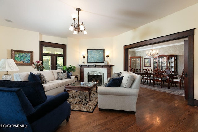 living area with french doors, a fireplace, dark wood finished floors, and an inviting chandelier