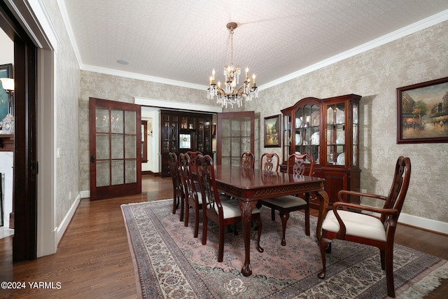 dining space featuring crown molding, dark wood-type flooring, and wallpapered walls