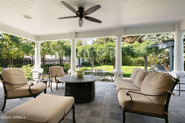 view of patio with an outdoor living space, outdoor dining area, fence, and a ceiling fan