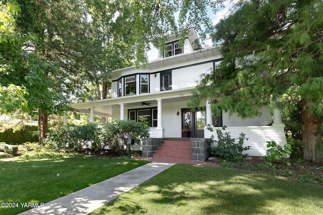 view of front facade featuring a porch, a front lawn, and a ceiling fan