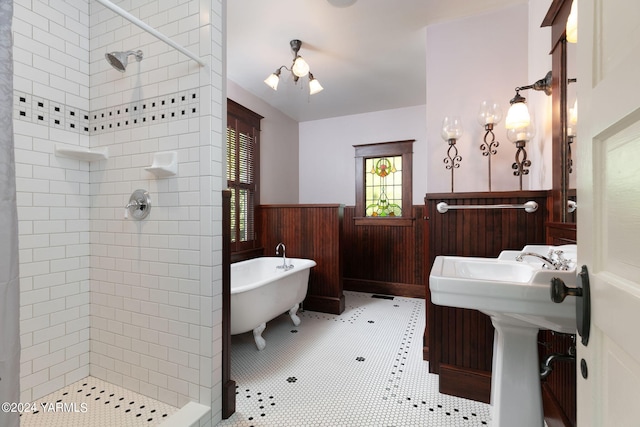 bathroom featuring a soaking tub, wainscoting, wood walls, and a shower stall