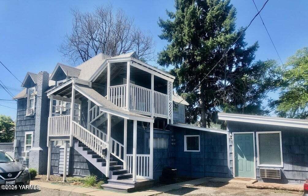 705 E Lincoln Ave, Yakima, WA 98901 - rear view of house featuring a balcony and stairway