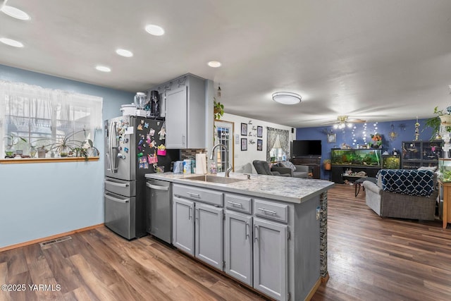 7501 Glacier Way, Yakima, WA 98908 - kitchen featuring gray cabinetry, appliances with stainless steel finishes, a peninsula, a sink, and healthy amount of natural light