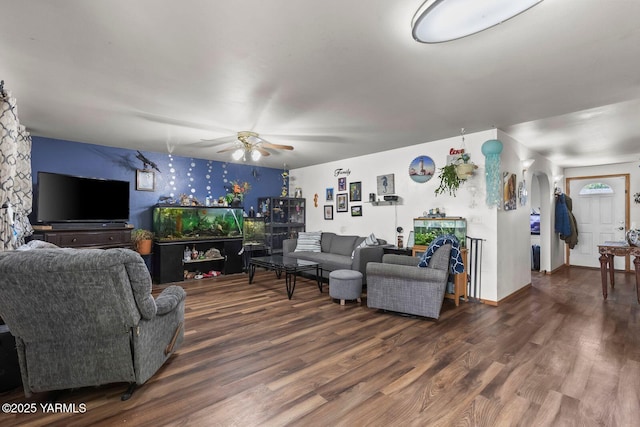7501 Glacier Way, Yakima, WA 98908 - living room with ceiling fan, wood finished floors, arched walkways, an accent wall, and wallpapered walls