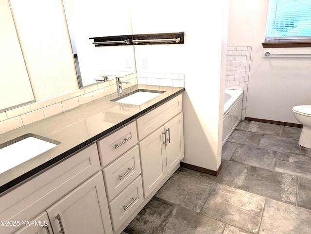 121 Lyle Loop Rd, Selah, WA 98942 - bathroom with stone finish flooring, decorative backsplash, double vanity, and a bath