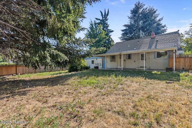 509 N 32nd Ave, Yakima, WA 98902 - back of house featuring a chimney, a patio area, and brick siding