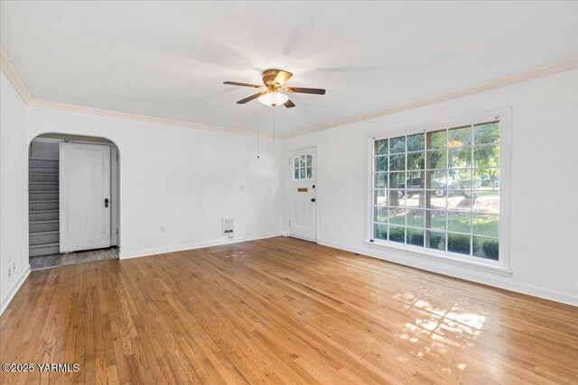 509 N 32nd Ave, Yakima, WA 98902 - spare room featuring a ceiling fan, arched walkways, crown molding, light wood-type flooring, and stairway