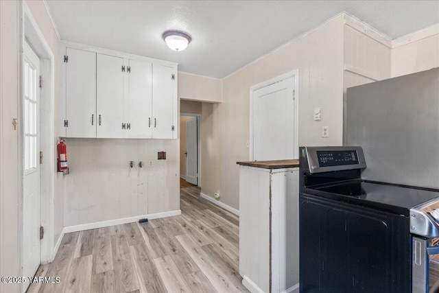 509 N 32nd Ave, Yakima, WA 98902 - kitchen featuring electric range, light wood-style flooring, and white cabinets