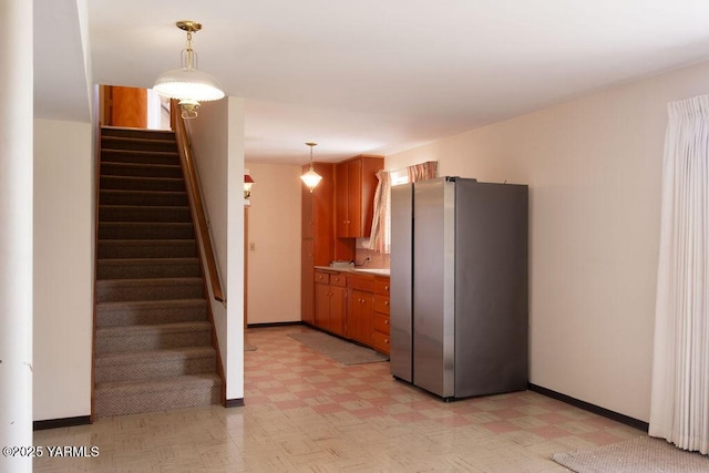 3606 Richey Rd, Yakima, WA 98902 - kitchen with freestanding refrigerator, light floors, brown cabinets, and pendant lighting