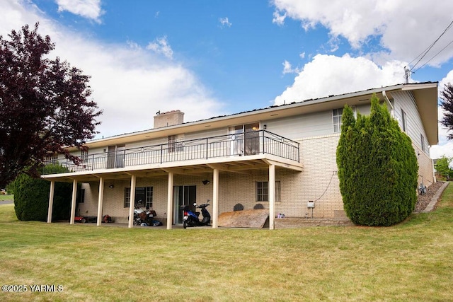 3606 Richey Rd, Yakima, WA 98902 - back of property featuring brick siding, a lawn, a chimney, and a wooden deck