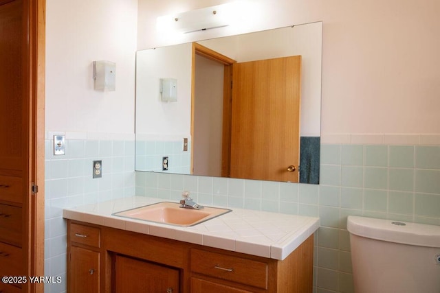 3606 Richey Rd, Yakima, WA 98902 - half bath with vanity, tile walls, toilet, and a wainscoted wall