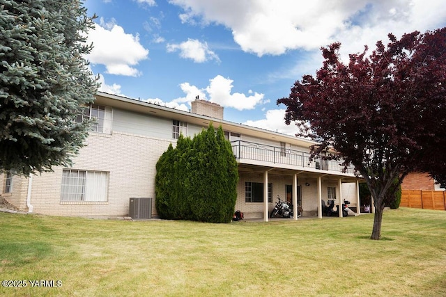 3606 Richey Rd, Yakima, WA 98902 - back of property with a chimney, a deck, central AC unit, and brick siding