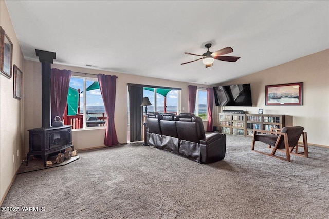 3501 S 40th Ave, Yakima, WA 98903 - living room featuring a wood stove, a ceiling fan, carpet floors, and vaulted ceiling