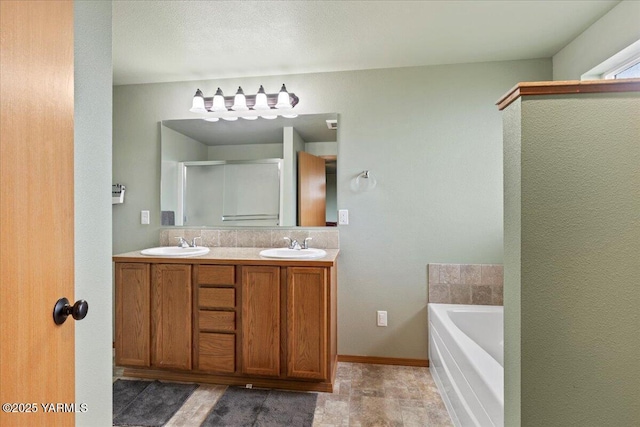 3501 S 40th Ave, Yakima, WA 98903 - full bathroom featuring a garden tub, double vanity, a shower stall, and baseboards