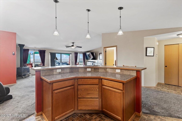 3501 S 40th Ave, Yakima, WA 98903 - kitchen featuring open floor plan, tile countertops, a wood stove, and hanging light fixtures