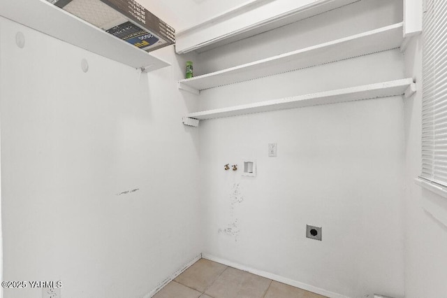 1713 S 10th Ave, Yakima, WA 98902 - laundry room with hookup for an electric dryer, light tile patterned flooring, and washer hookup