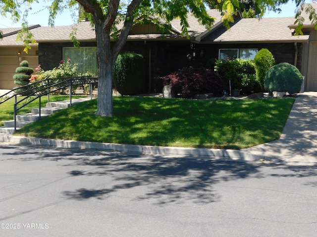 view of front of house featuring a front yard and stairs