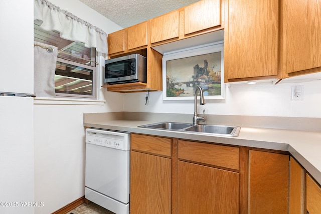 112 N 53rd Ave, Yakima, WA 98908 - kitchen featuring white appliances, a sink, light countertops, and a textured ceiling