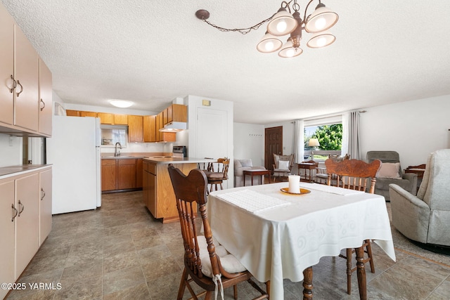 112 N 53rd Ave, Yakima, WA 98908 - dining area featuring a chandelier, a textured ceiling, and stone finish flooring