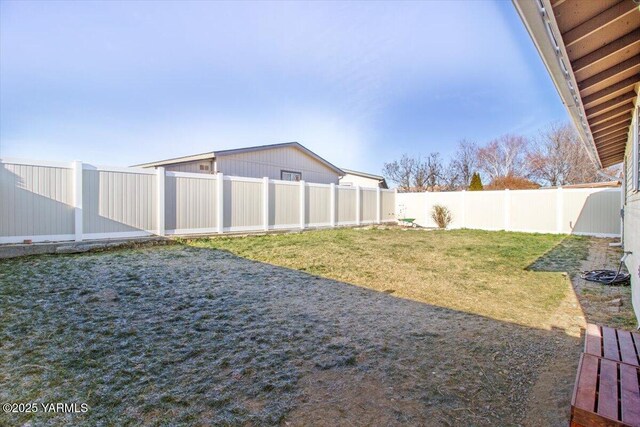 view of yard with a fenced backyard