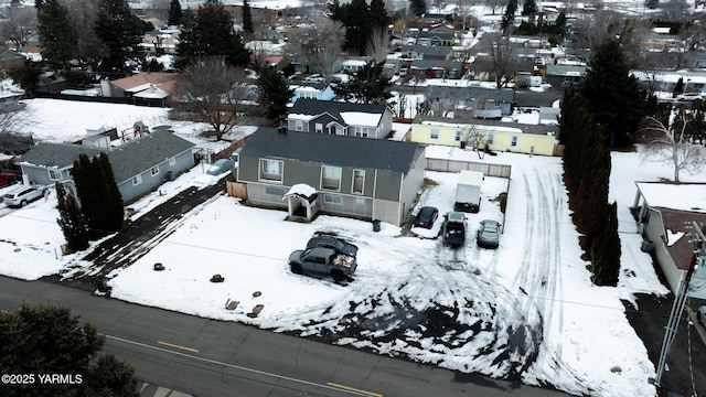 snowy aerial view featuring a residential view