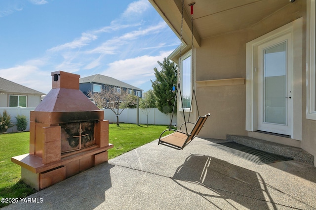 view of patio featuring exterior fireplace