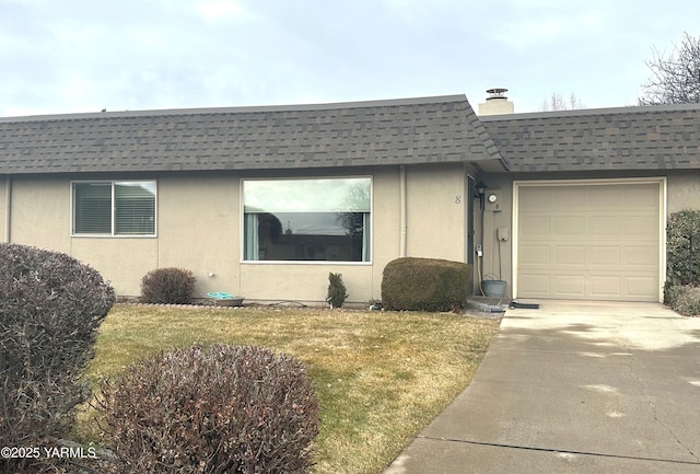 view of front facade with a front yard, roof with shingles, driveway, and stucco siding