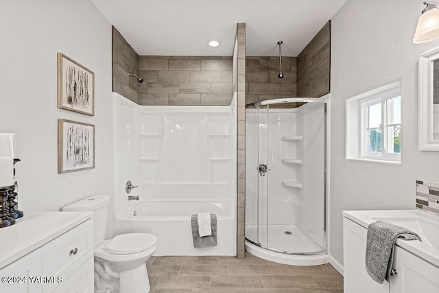 bathroom featuring toilet, wood finish floors, a shower, and vanity