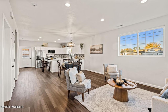 interior space with baseboards, dark wood finished floors, a wealth of natural light, and recessed lighting